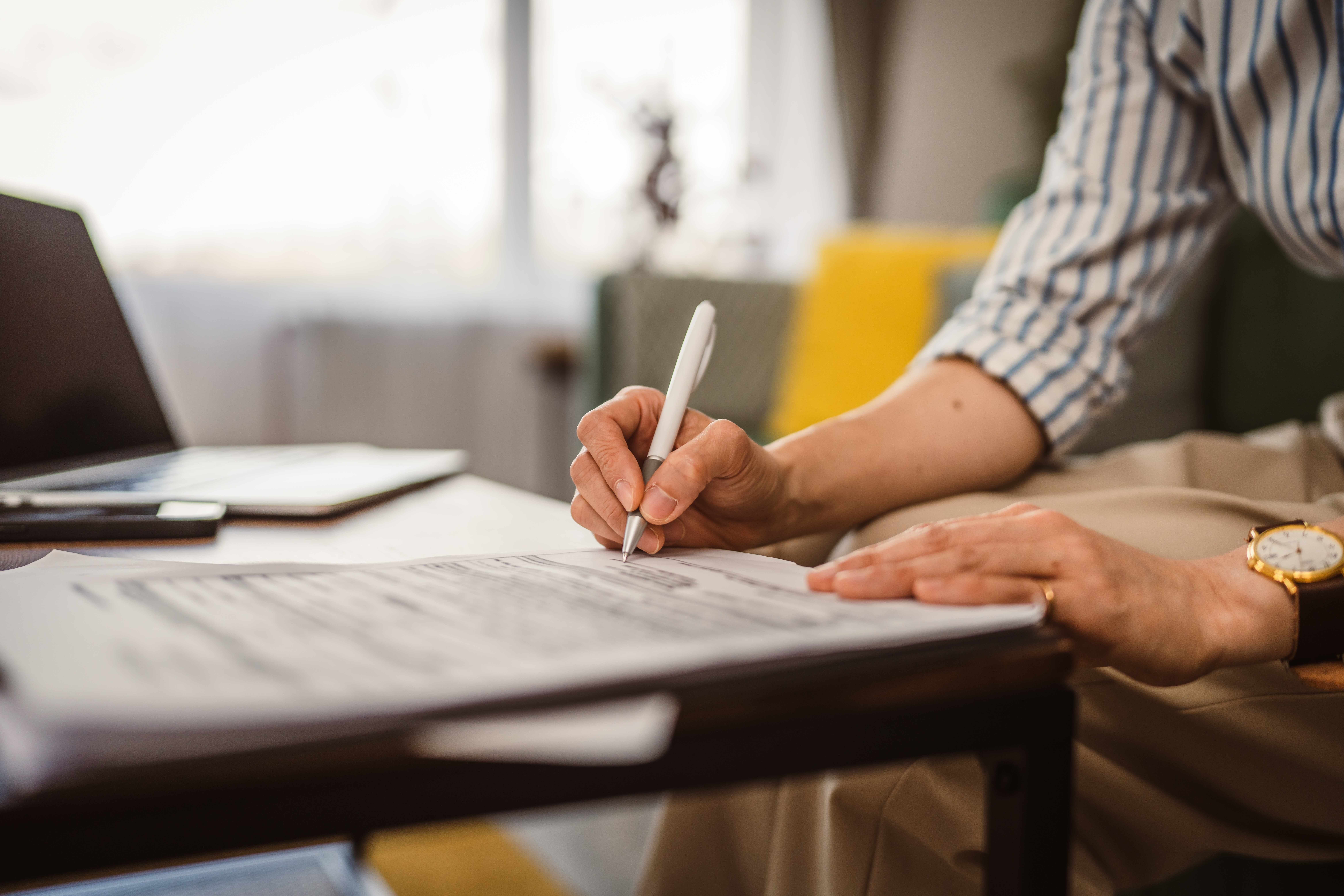 close up of lawyer signing paperwork