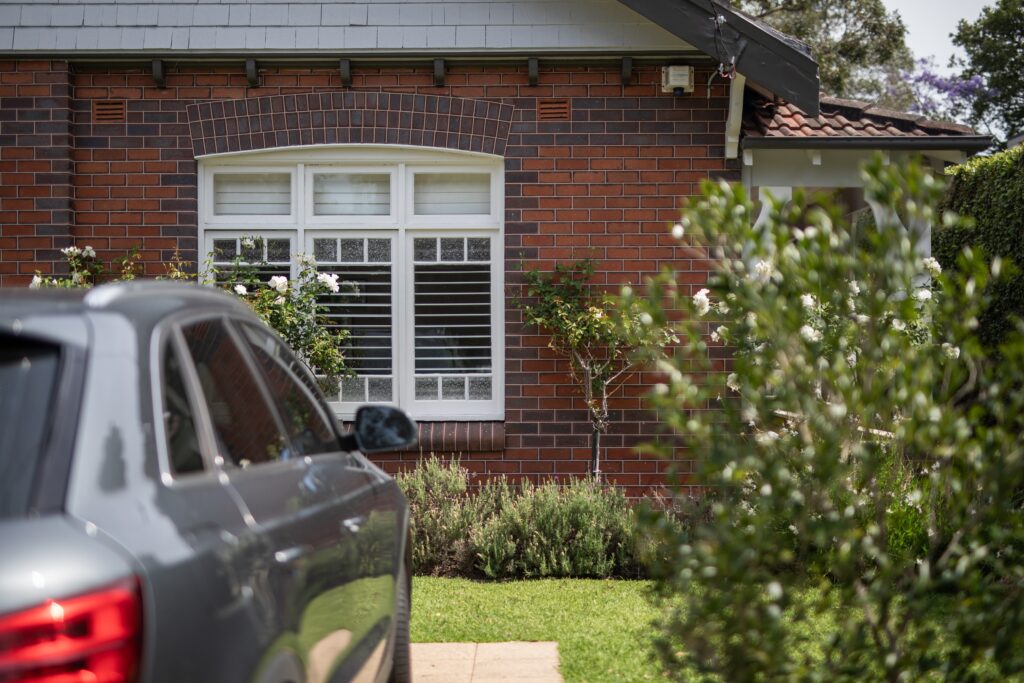 Suburban house with car parked out the front